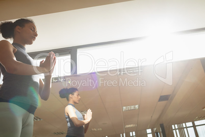 Woman performing yoga in gym