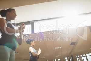 Woman performing yoga in gym