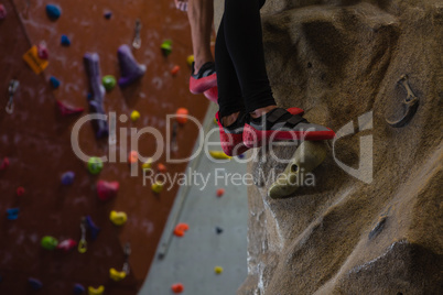 Low section of athletes rock climbing at studio