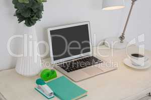 Laptop and office accessories on table