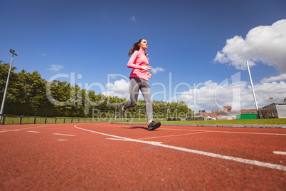 Woman jogging on a race track