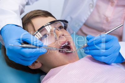 Boy wearing eyewear taking dental treatment