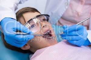 Boy wearing eyewear taking dental treatment