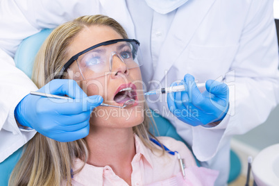Woman receiving dental treatment at medical clinic