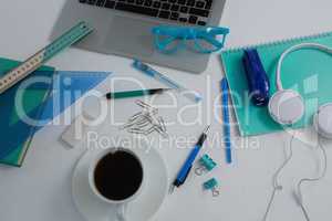 Laptop, black coffee and stationery on white background