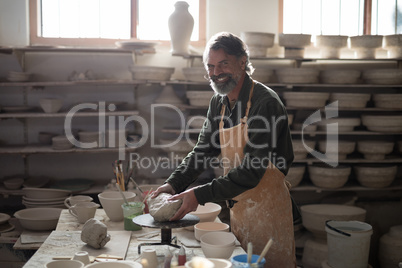 Portrait of male potter molding a clay