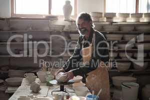 Portrait of male potter molding a clay