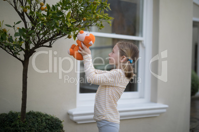 Young girl holding soft toy