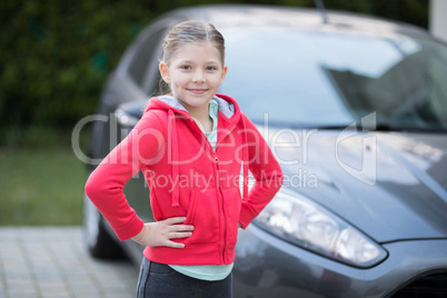 Teenage girl standing near the car