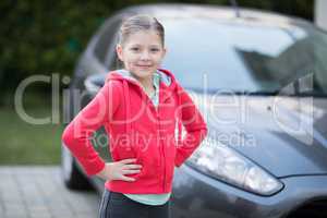 Teenage girl standing near the car