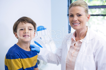 Portrait of happy dentist with boy