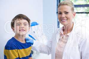 Portrait of happy dentist with boy
