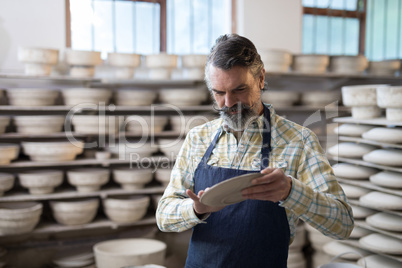 Male potter checking plate