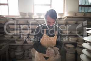 Male potter molding a clay