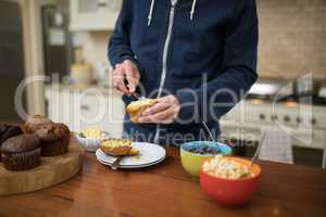 Man preparing muffins in the kitchen