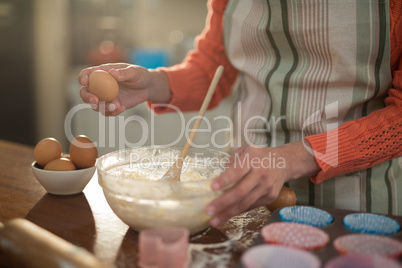 Woman preparing cookies in kitchen