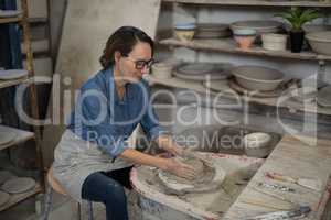 Female potter molding a clay