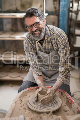Portrait of male potter molding a clay