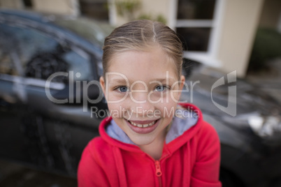 Teenage girl standing near the car