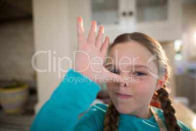 Young girl making funny faces at home