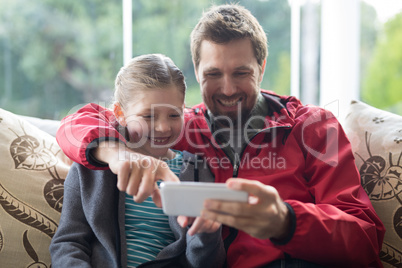 Father and daughter using mobilephone