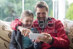 Father and daughter using mobilephone