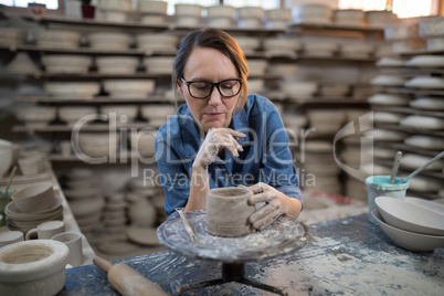 Female potter molding a clay