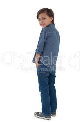 Boy posing with hands in pocket against white background