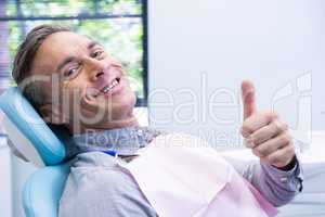 Portrait of smiling man showing thumbs