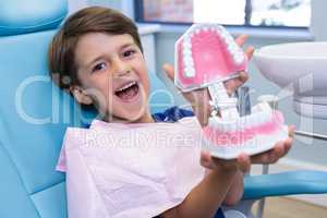 Portrait of cute boy holding dental mold