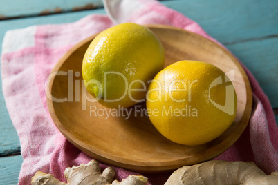 Close up of lemon in wooden plate