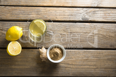 Herbal tea cup with lemon and ginger on table