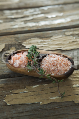 Himalayan salt with rosemary in wooden bowl