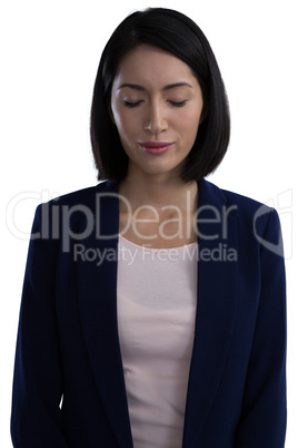 Businesswoman standing with her eyes closed