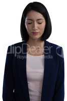 Businesswoman standing with her eyes closed