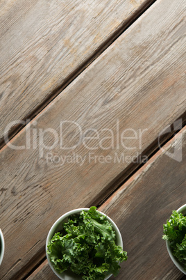 Overhead view of freshn kale in bowls on table