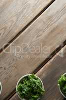 Overhead view of freshn kale in bowls on table