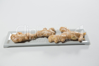 Close up of fresh gingers on gray plastic tray