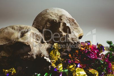 Close up of skull with colorful wrapped chocolates