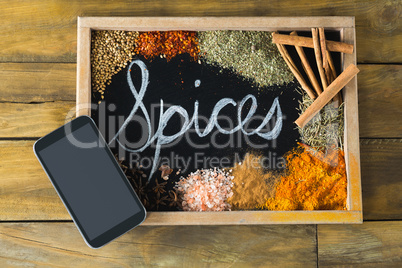Various type of spices on slate and mobile phone