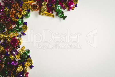 Colorful wrapped chocolates on white background