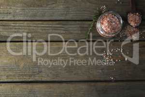 Himalayan salt and rosemary on wooden table