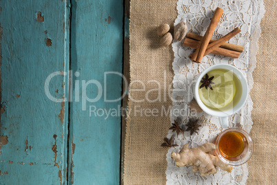 Overhead view of cinnamons with ginger tea on burlap