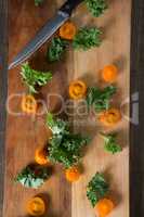 Kale with tomato slices on cutting board