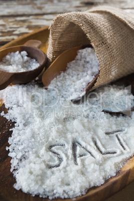 Word salt on wooden plate