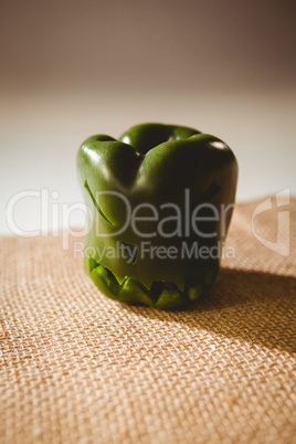 Carved green bell pepper on sack