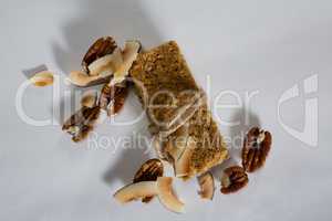 Granola bar tied with string and dried fruits kept around