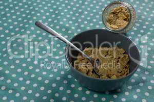 Bowl of wheat flakes with spoon