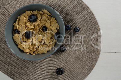 Bowl of wheat flakes and blueberry