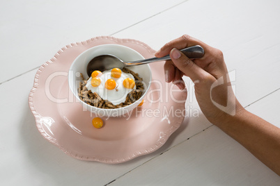 Close-up of womans hand having healthy breakfast